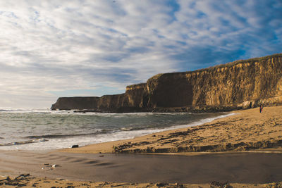 Scenic view of beach by sea