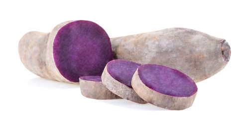 Close-up of pebbles on rock against white background