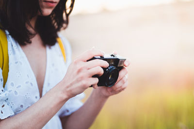 Midsection of woman photographing