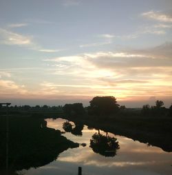 Reflection of clouds in lake at sunset