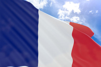 Low angle view of flag against blue sky