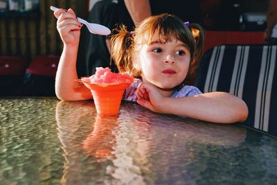 Boy holding drink sitting in water