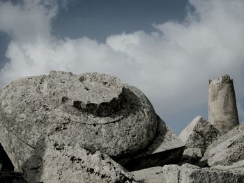 Rock formations against cloudy sky