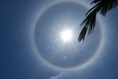 Low angle view of bright sun in sky