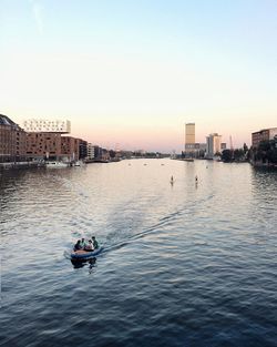 Scenic view of river against sky in city