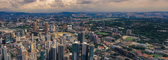 High angle view of illuminated city buildings against sky