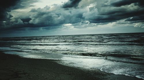 Scenic view of sea against cloudy sky