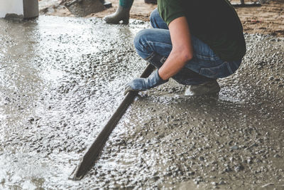 Low section of man working in water