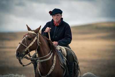 Man riding horse on a field