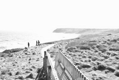 Three distant people on sunny australian beach 