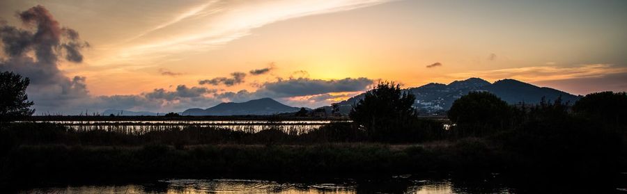 Scenic view of landscape against sky at sunset