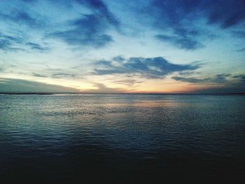 Scenic view of sea against cloudy sky