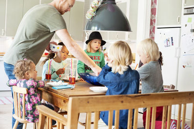 Father and children in kitchen