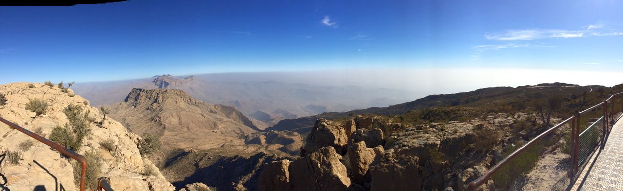 mountain, sky, scenics - nature, tranquil scene, beauty in nature, environment, tranquility, landscape, mountain range, non-urban scene, nature, idyllic, no people, rock, day, cloud - sky, geology, physical geography, blue, sunlight, outdoors, formation, mountain peak, eroded