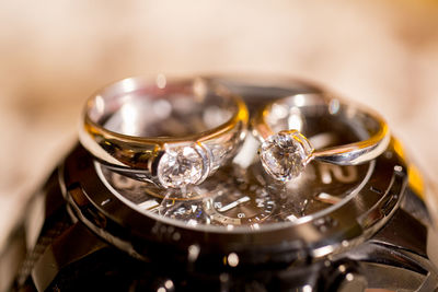 Close-up of wedding rings on watch