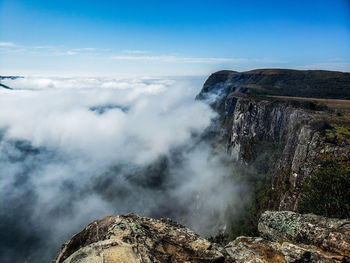 Scenic view of clouds over mountain against sky