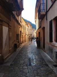 Narrow alley amidst buildings in town