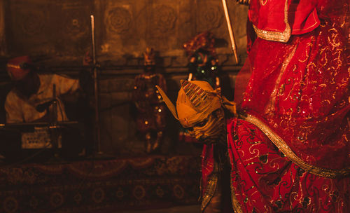 Midsection of woman with red umbrella