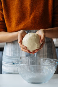 Midsection of woman holding ice cream in bowl