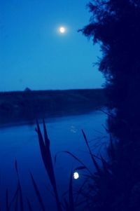 Scenic view of lake against blue sky