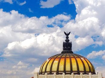 Low angle view of building against cloudy sky
