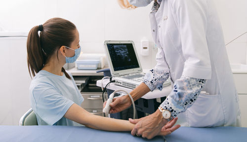 Doctor examining patient at clinic