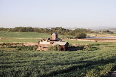 Barn on field against sky