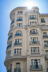 Low angle view of building against sky and sun