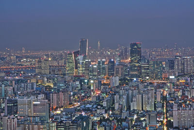 Aerial view of city lit up at night