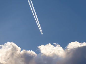 Low angle view of airplane flying against sky