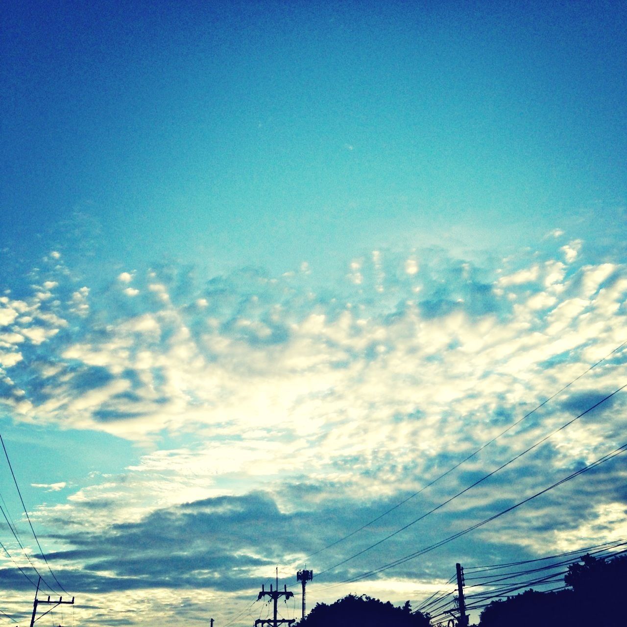 sky, power line, blue, electricity pylon, low angle view, cloud - sky, electricity, silhouette, power supply, tranquility, beauty in nature, scenics, sunset, connection, tranquil scene, nature, cloud, cable, outdoors, no people