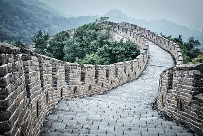 Architectural detail of stone wall with mountain in background