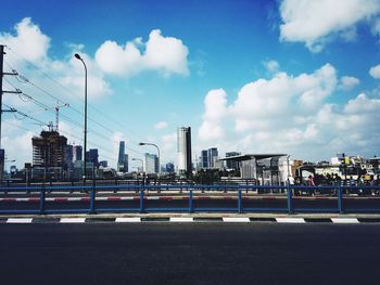 City street by buildings against sky