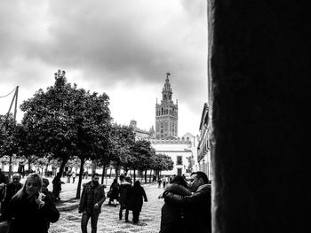 People walking at temple against sky