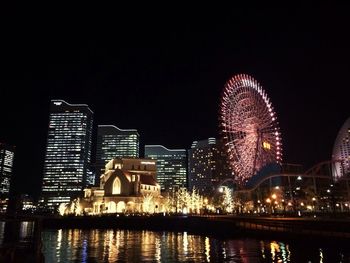 Low angle view of illuminated ferris wheel at night