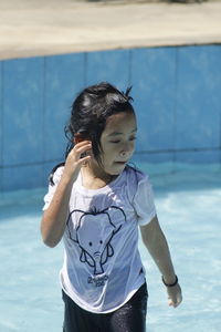 Full length of girl standing in swimming pool