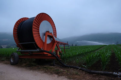 Agricultural machinery on field against sky