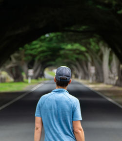 Rear view of man standing on road