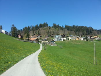 Panoramic view of trees and houses against clear sky