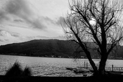 Scenic view of river by mountains against sky