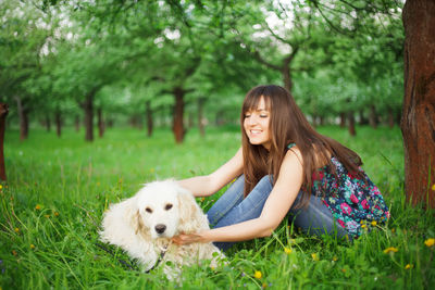 Young woman with dog on field