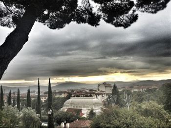 View of buildings against cloudy sky at sunset