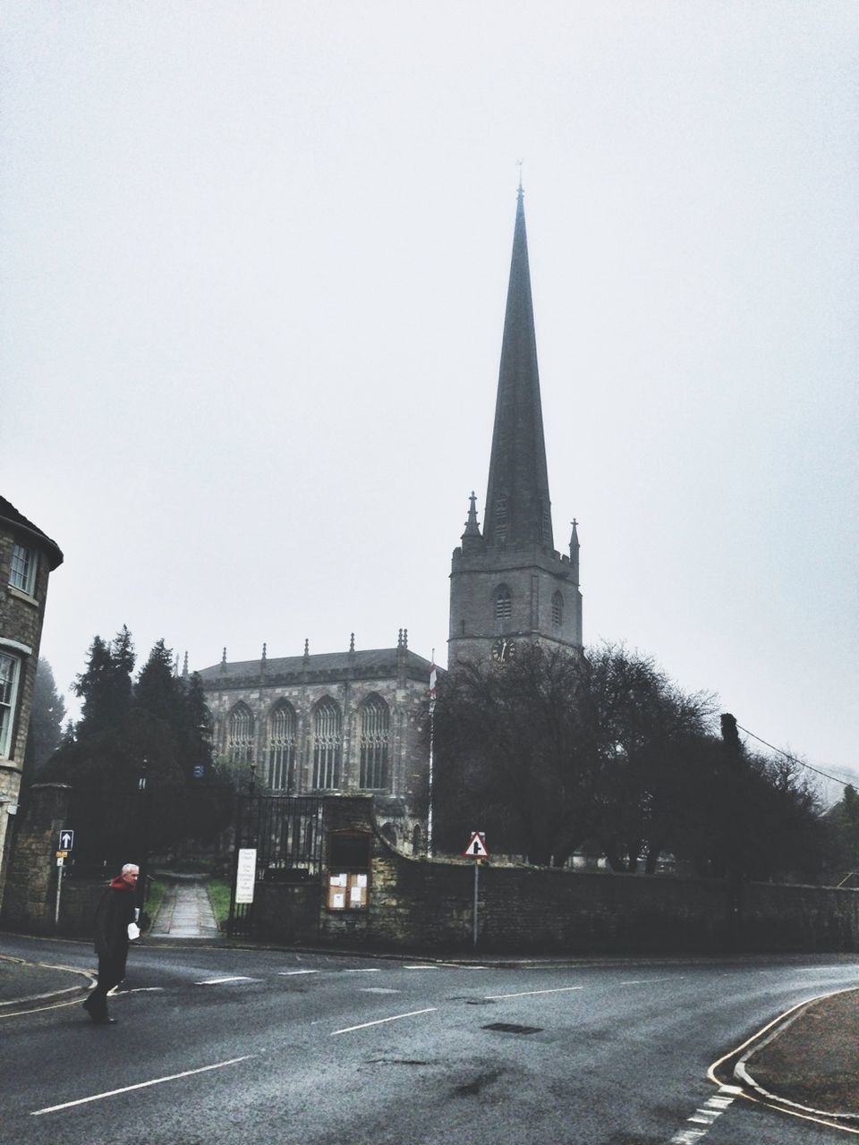 building exterior, architecture, clear sky, built structure, church, road, religion, transportation, place of worship, street, copy space, spirituality, the way forward, sky, incidental people, car, tree, road marking