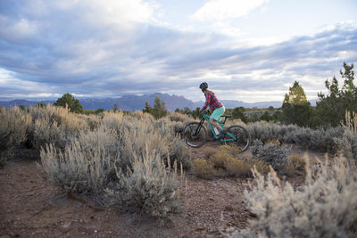 A woman riding her mountain bike on gooseberry mesa, utah