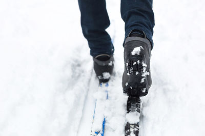 Close-up of skier walking in snow