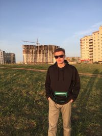 Portrait of man wearing sunglasses while standing in city