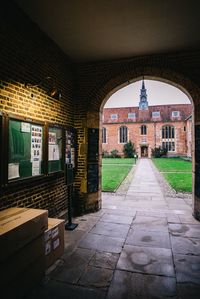 Footpath amidst buildings in city