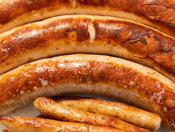 Fine bratwurst fried in the pan in a close-up