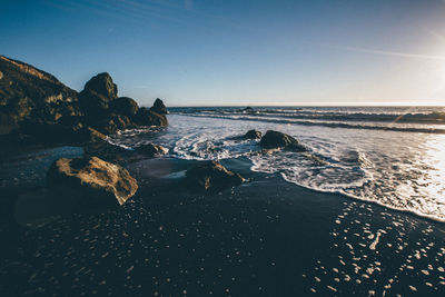 Scenic view of sea against clear sky at sunset