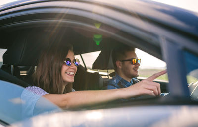 Young couple driving car